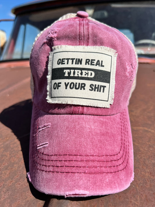 Red Distressed Baseball cap with material patch saying" Gettin Real Tired of yout Shit" 