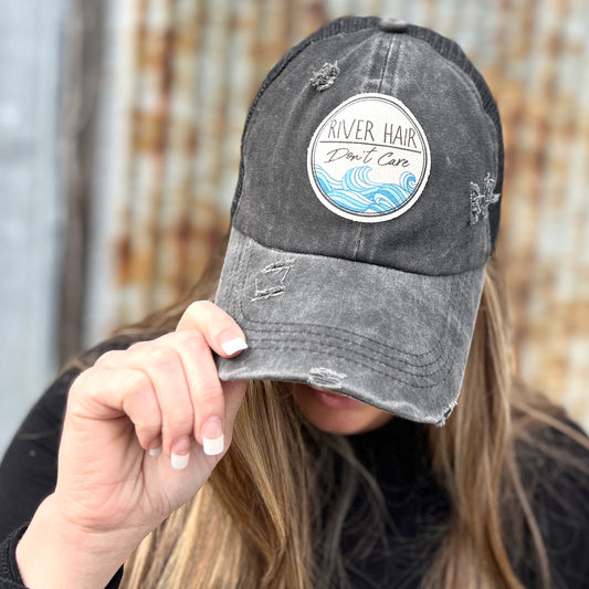 Black Distressed womens cap with material patch saying "river hair dont care" 