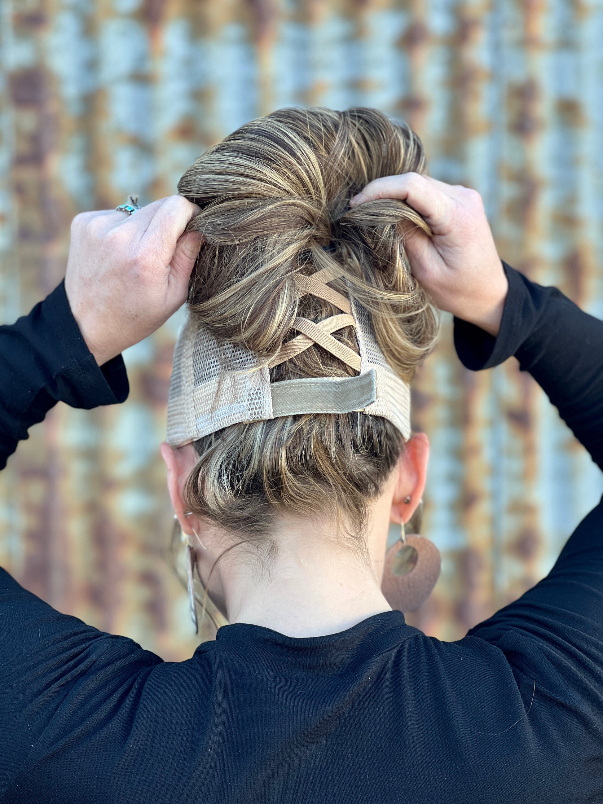 Back of Khaki baseball cap. Criss Cross back with stretchy bands and adjustable velcro  strap.