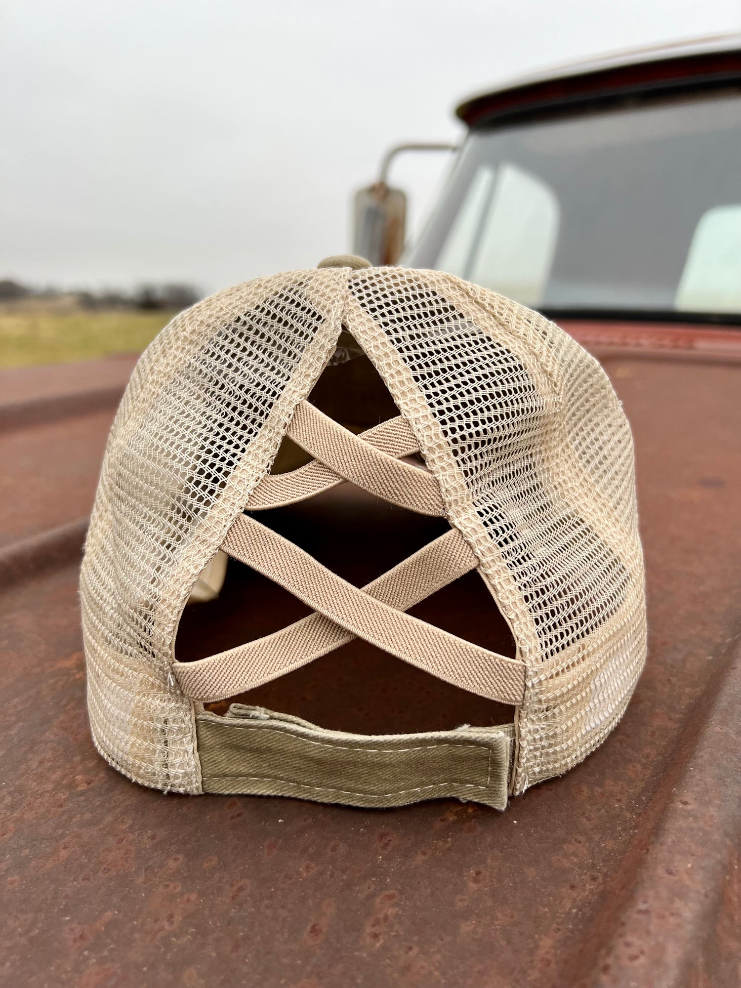 Back of Distressed Khaki ponytail cap with stretchy bands 