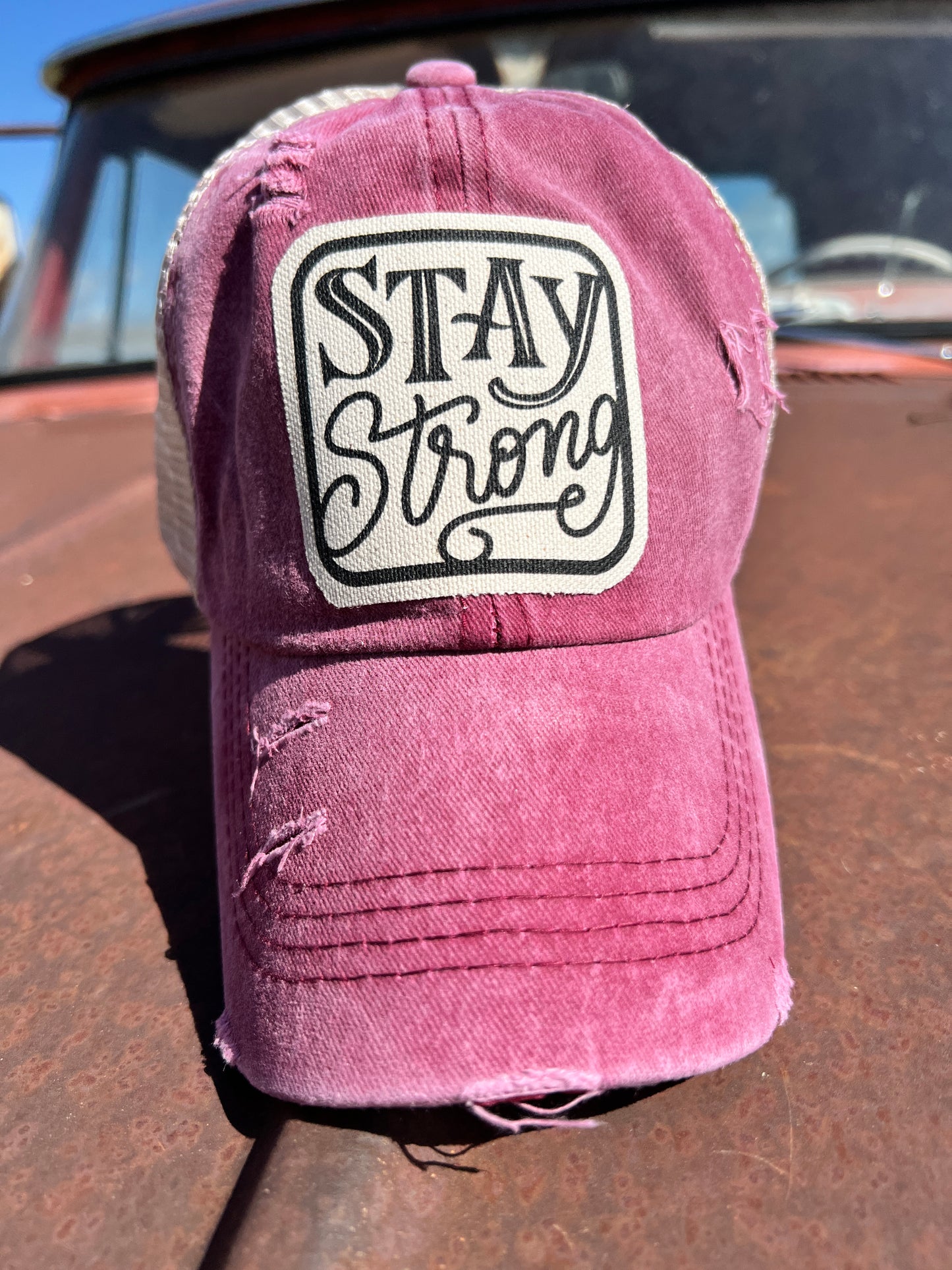 Stay Strong material patch on red distressed baseball cap 