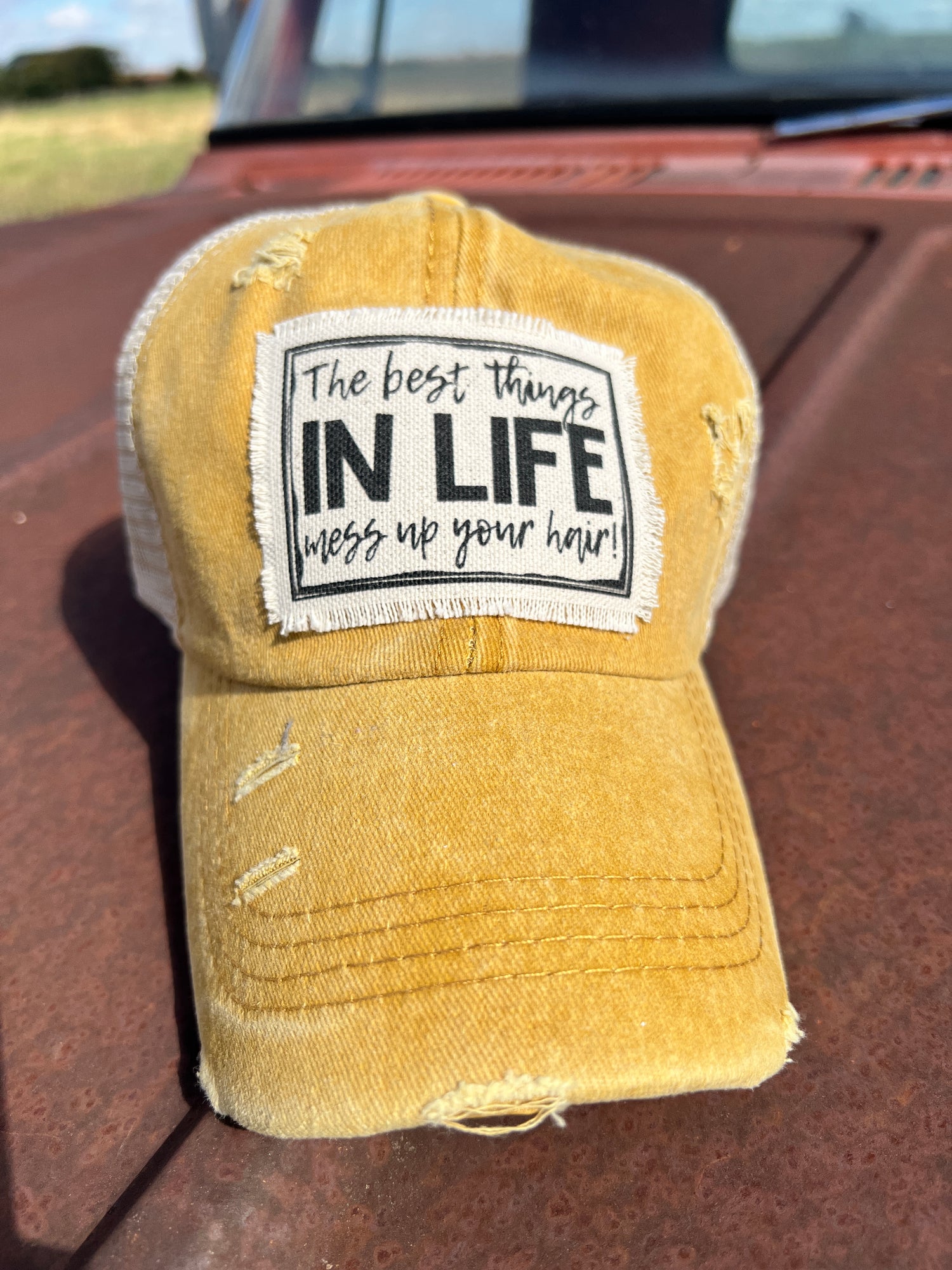 Mustard baeball cap with material patch with saying" The Best things in life Mess up your Hair"